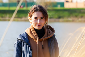 Portrait joyful young woman brunette in brown  sweater and coat having fun, smile and enjoy day on...