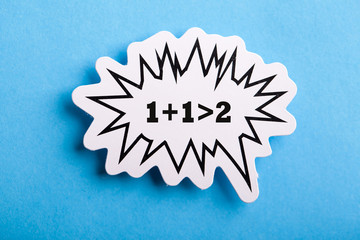 Synergy 1+1>2 Speech Bubble Isolated On Blue Background