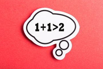 Synergy 1+1>2 Speech Bubble Isolated On Red Background