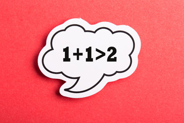 Synergy 1+1>2 Speech Bubble Isolated On Red Background