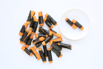 Nori maki arare japanese rice crackers in seaweed on white background.