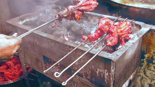 Video/footage of grilling of chiken on the grills using coal and other natural flavoring agents,Dish popular of Ramadan/Ramzan served in iftar,.