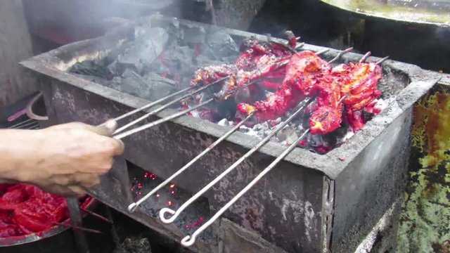Video/footage of grilling of chiken on the grills using coal and other natural flavoring agents,Dish popular of Ramadan/Ramzan served in iftar,.