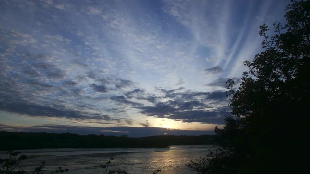Atmospheric view of a beautiful sunset at a local Cornish estuary in Cornwall. TIMELAPSE.
