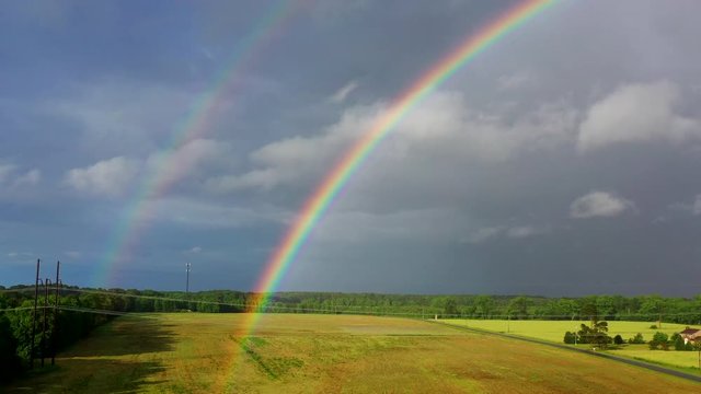 Aerial drone panning past rainbow
