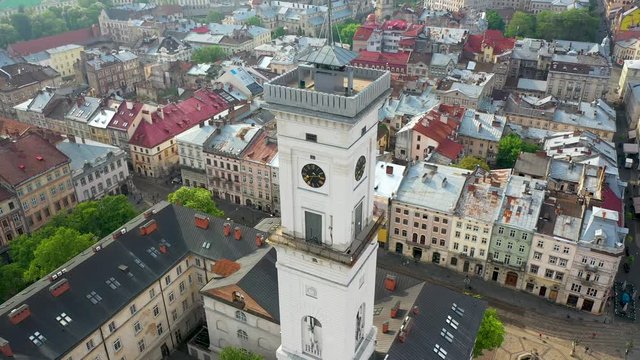 Flying near the town hall in the city of Lviv with rainy weather with clouds