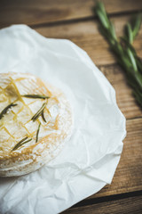 Baked camembert cheese with toasts and rosemary herbs on the rustc background. Selective focus. Shallow depth of field.