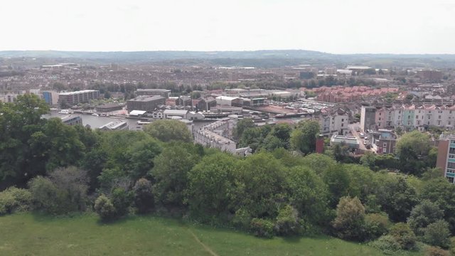 Drone lowering into inner city green space, Bristol UK