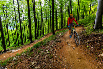 Cycling man riding on bike in mountains forest landscape. Cycling MTB enduro flow trail track. Outdoor sport activity.