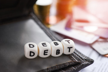 Debt credit card and money coin stack / Increased liabilities from exemption debt consolidation