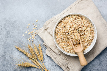 Oat flakes, oats or rolled oats in bowl. Table top view - 270140136