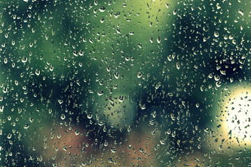 Water drops on glass during a rain close up. Natural background