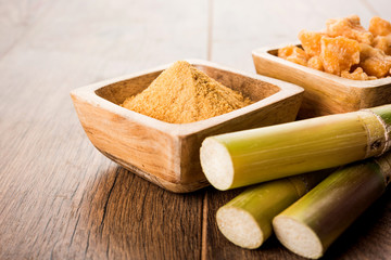 Organic Gur or Jggery Powder is unrefined sugar obtained from concentrated sugarcane juice. served in a bowl. selective focus