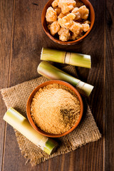 Organic Gur or Jggery Powder is unrefined sugar obtained from concentrated sugarcane juice. served in a bowl. selective focus