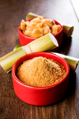 Organic Gur or Jggery Powder is unrefined sugar obtained from concentrated sugarcane juice. served in a bowl. selective focus