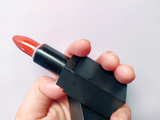 hand put coral or orange brick lipstick on background white use for makeup women beautiful  so much 