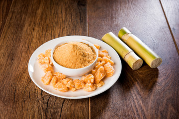 Organic Gur or Jggery Powder is unrefined sugar obtained from concentrated sugarcane juice. served in a bowl. selective focus