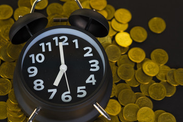 Alarm clock and coins stacks on working table, time for savings money concept, banking and business concept