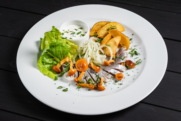 herring with baked potato and sauce