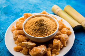 Organic Gur or Jggery Powder is unrefined sugar obtained from concentrated sugarcane juice. served in a bowl. selective focus