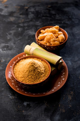 Organic Gur or Jggery Powder is unrefined sugar obtained from concentrated sugarcane juice. served in a bowl. selective focus