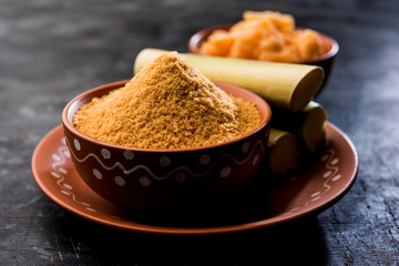 Organic Gur or Jggery Powder is unrefined sugar obtained from concentrated sugarcane juice. served in a bowl. selective focus