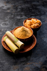 Organic Gur or Jggery Powder is unrefined sugar obtained from concentrated sugarcane juice. served in a bowl. selective focus