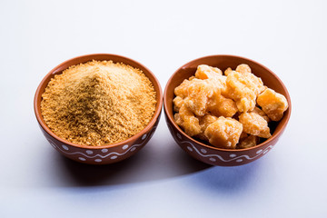 Organic Gur or Jggery Powder is unrefined sugar obtained from concentrated sugarcane juice. served in a bowl. selective focus
