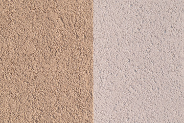 The texture of the plastered wall of fine grain divided into two halves in different colors