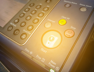 Hand press button on panel of printer, Finger pressing the start button on a multifunction printer.