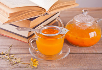Sea buckthorn tea in a glass cup. Herbal vitamin tea.