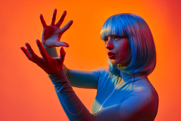 Futuristic woman forming invisible orb