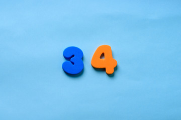 34 years old celebrating classic logo. Colored happy anniversary 34 th orange blue numbers....