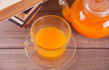 Sea buckthorn tea in a glass cup. Herbal vitamin tea.