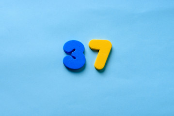 37 years old celebrating classic logo. Colored happy anniversary 37 th template yellow blue...