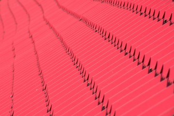 Abstract background texture, architectural details,red ceramic roof tiles in seamless diagonal pattern on sunny day.