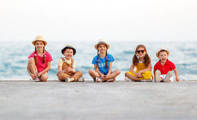 group of happy children by   sea in summer.