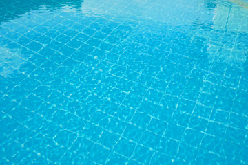 water rippled on swimming pool water surface for background