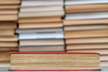 Old book in the red obnozhka. Symbol of knowledge and learning.