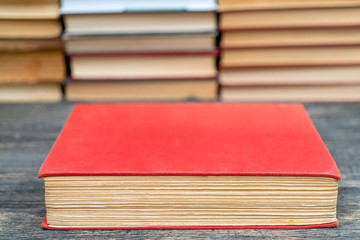 Old book in the red obnozhka. Symbol of knowledge and learning.