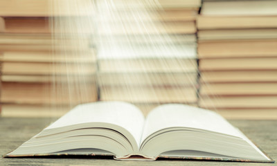 Book pages emit light. Symbol of wisdom, knowledge and learning.