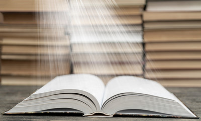 Book pages emit light. Symbol of wisdom, knowledge and learning.