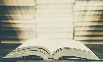 Book pages emit light. Symbol of wisdom, knowledge and learning.