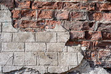 Fototapeta premium Broken surface of old brick wall