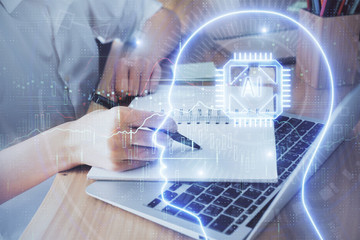 Multi exposure of writing hand on background with brain hologram. Concept of self learning.