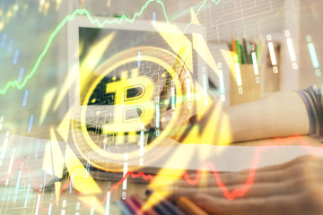 Cryptocurrency hologram, bitcoin, ico theme over hands taking notes background. Concept of blockchain. Multi exposure