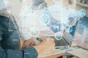 Social network theme hologram with businessman working on computer on background. Multi exposure.