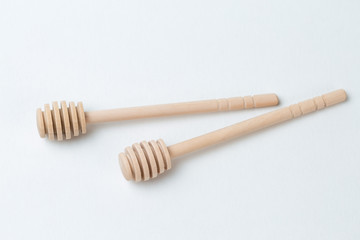 Wooden sticks for honey on a white background	