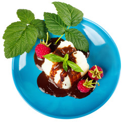 Cream pudding with chocolate sauce, raspberry and mint on tablecloth. Top view flat lay group objects