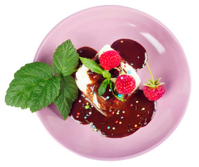 Cream pudding with chocolate sauce, raspberry and mint on beauti